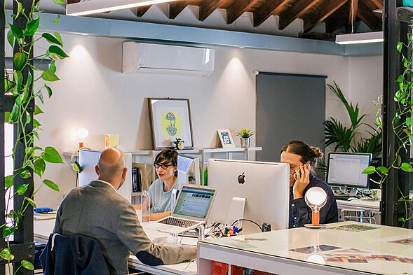 men using computers while watching female coworker, office love, office romance