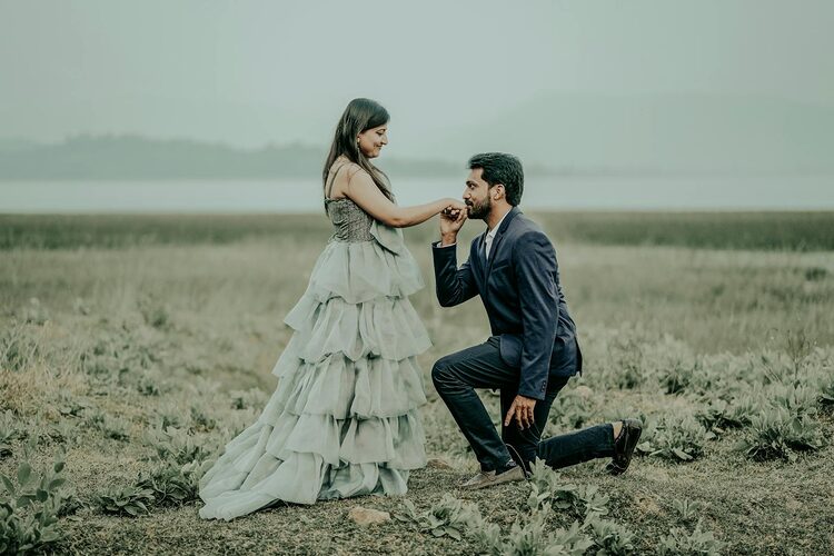 Love and respect, Man in a Suit Kneeling in front of a Woman in a Dress and Kissing Her Hand 