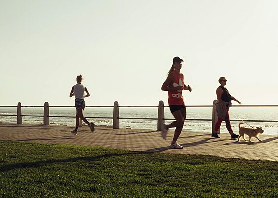 Active various women with dog on seafront