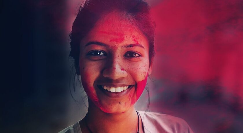 Woman smiling in Holi, Skin and hair colored