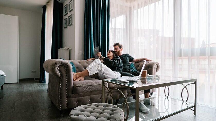 Quality time in relationship, man in gray dress shirt sitting on gray sofa chair