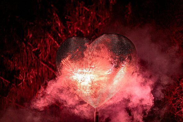 a heart - shaped object is surrounded by smoke