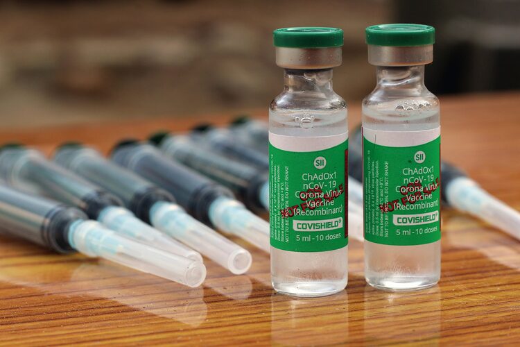 a group of bottles of liquid sitting on top of a wooden table